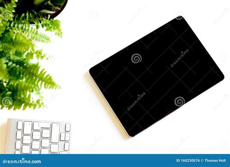 Blank White Screen On Portable Tablet Device On Modern Office Desk