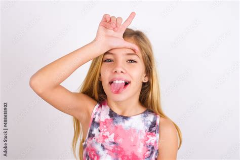 Funny Little Caucasian Kid Girl Wearing Sport Clothing Over White