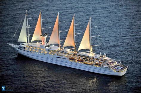 an aerial view of a cruise ship in the ocean with orange sails and ...