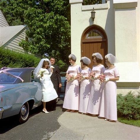 A Group Of Women Standing Next To Each Other In Front Of A Car