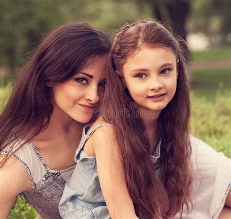 Beautiful Mother Hugging And Kissing Her Cute Small Daughter On Summer