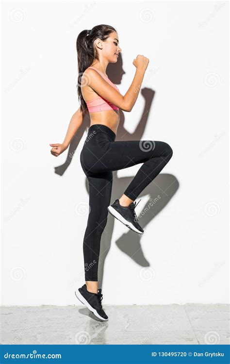 Attractive Excited Fitness Girl In Sportwear Jumping Isolated Over