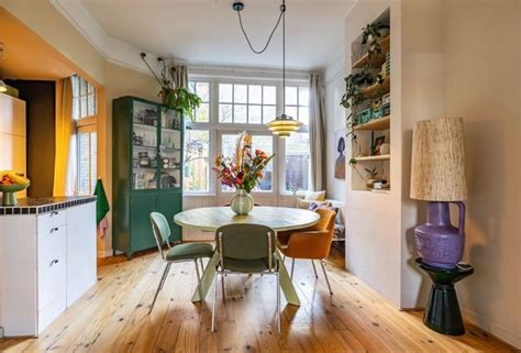 A Dining Room Table And Chairs In Front Of A Window