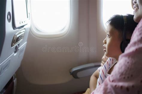 Asian Kid Enjoying And Watching Cartoons With His Mother During The