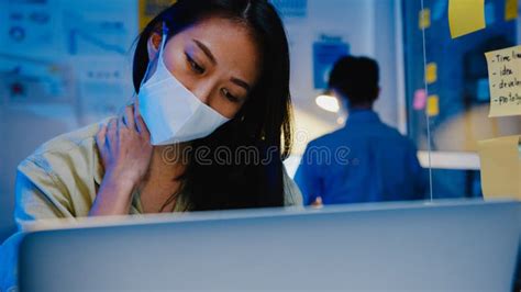 Stressed Tired Young Asia Woman Wear Face Mask Using Laptop Hard Work