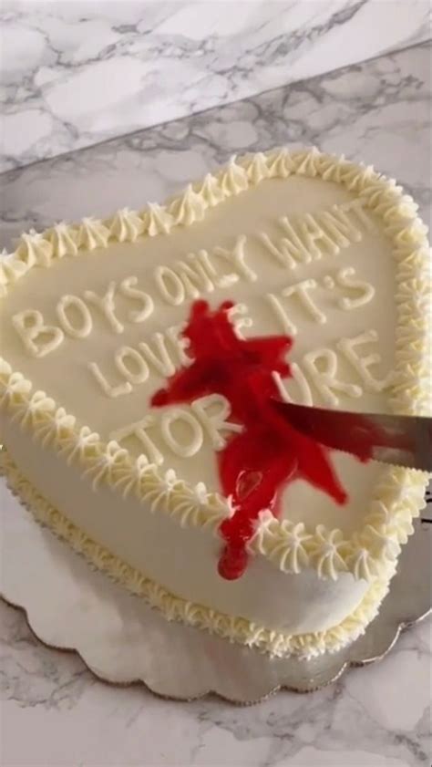 A Heart Shaped Cake With A Knife Stuck In The Middle And Writing On It