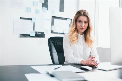 Young Blond Beautiful Woman Manager Works In Her Modern Office Looks