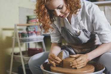 Woman Moulding Clay On Pottery Wheel Craftswoman Making Pot In