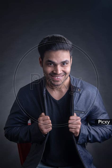 Image Of Portrait Of Young Attractive Indian Male Model Posing Over An Black Background Hx555484