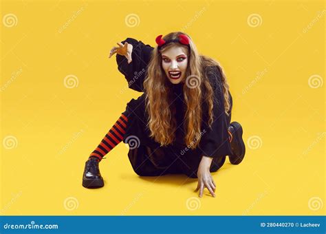 Scary Woman With Open Mouth Dressed As Devil For Halloween Crawling And