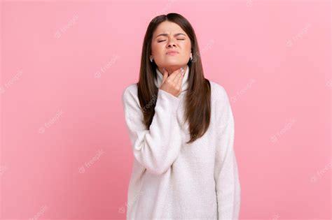 Premium Photo Portrait Of Sad Ill Woman Touching Her Neck Suffering