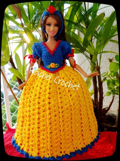 A Crocheted Doll Is Wearing A Yellow Dress