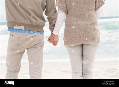 Happy Couple Holding Hands While Walking Stock Photo Alamy