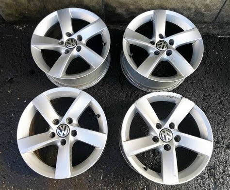 A Set Of Four Original Vw Volkswagen Passat Golf Alloy Wheels