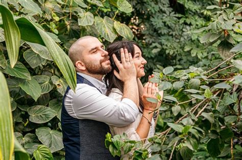 Premium Photo Beautiful Couple Girl And Guy In The Park Among Tropical Trees