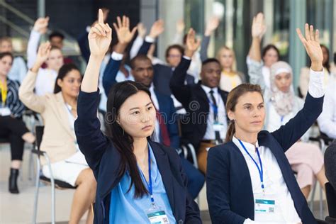 Business People Asking Question During Speech In Conference Room Stock