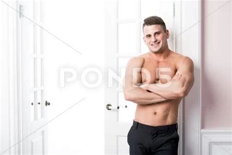 Portrait Of A Well Built Shirtless Muscular Male Model Arms Folded