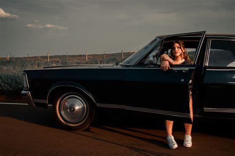 Woman Driving Vintage Car on Road during Daytime · Free Stock Photo