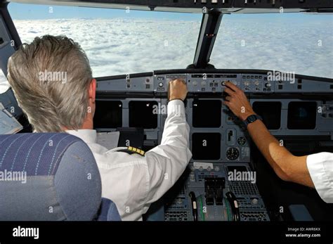 Pilots in the cockpit of an Airbus 321, in flight Stock Photo - Alamy