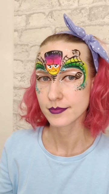 A Woman With Pink Hair And Makeup Has Her Face Painted Like A Cartoon