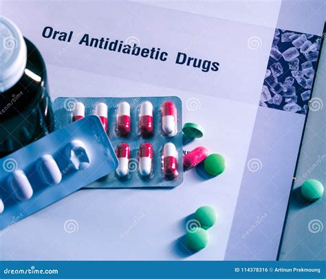 Diabetes Drugs in Packs and and Medicine Bottle Placed on Textbook. Green Tablets and Pink-white ...