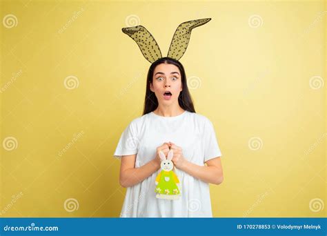 Easter Bunny Woman With Bright Emotions On Yellow Studio Background