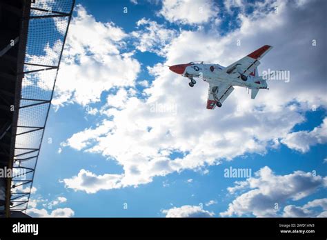 A T-45 Goshawk approaches the aircraft carrier USS Dwight D. Eisenhower ...