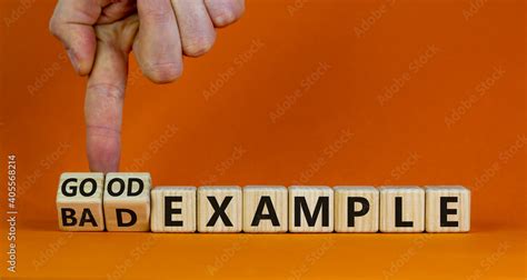 good  bad  symbol businessman turns wooden cubes