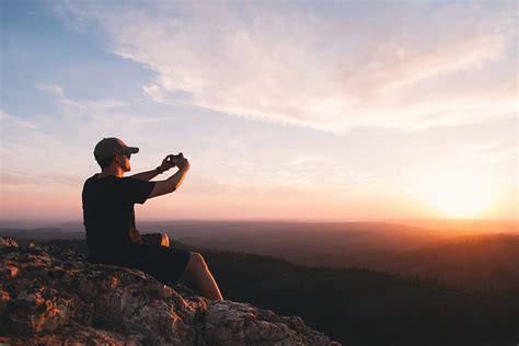 Hd Wallpaper Man Sitting On Mountain Cliff Taking Picture Photography