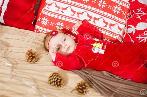 Cute Newborn Baby In A Christmas Costume On A Bed At Home Stock Photo