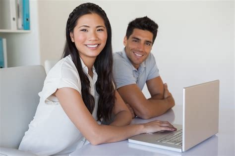 Premium Photo Casual Business Team Using Laptop Together At Desk