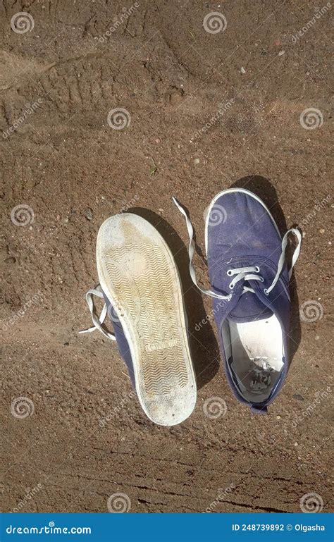 worn   dirty blue sneakers stock photo image  beach