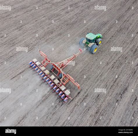 Sowing Of Corn Tractor With A Seeder On The Field Using A Seeder For