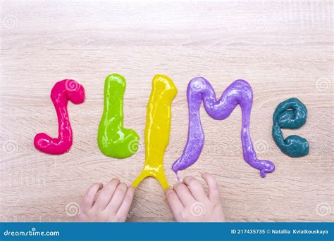 The Word Slime Made From Multi Colored Slimes On A Wooden Table Slime