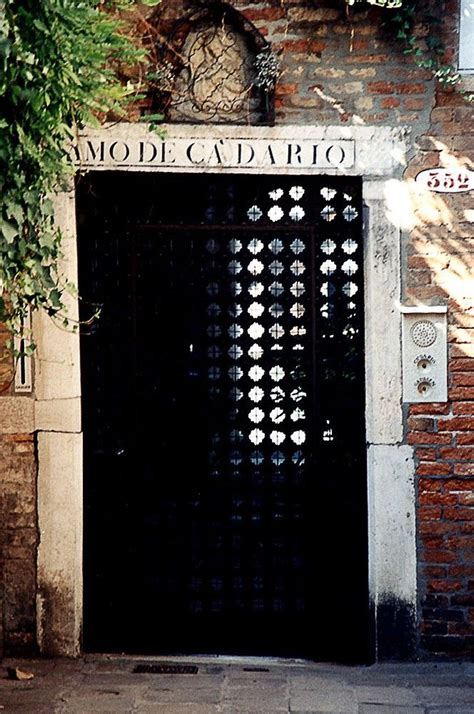 The Entrance To An Old Building With Vines Growing Up It S Sides And Doors