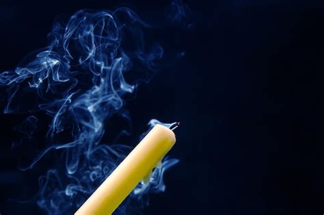 Premium Photo Smoke From An Extinguished Candle On A Dark Background