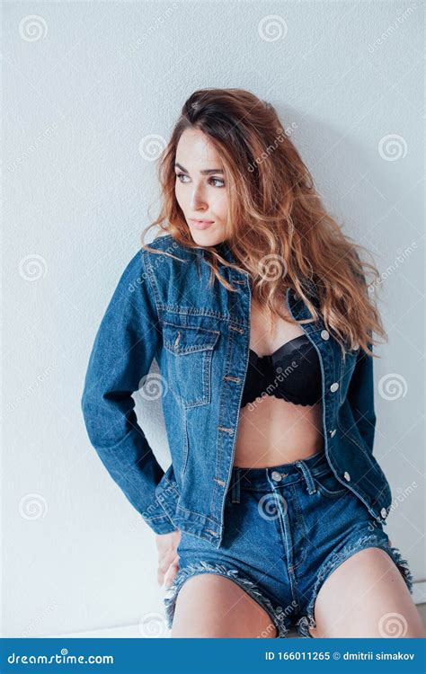 Portrait Of A Beautiful Fashionable Woman In Lingerie And Denim Shorts