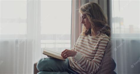 Premium Photo Attractive Woman Reading Book While Sitting On A Sofa