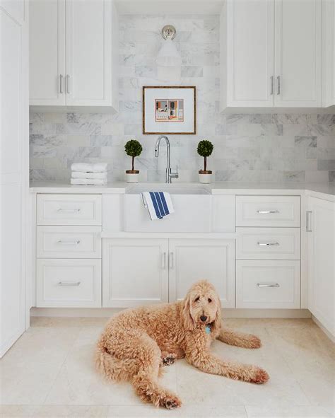 White Laundry Room With Honed Marble Subway Tile Backsplash