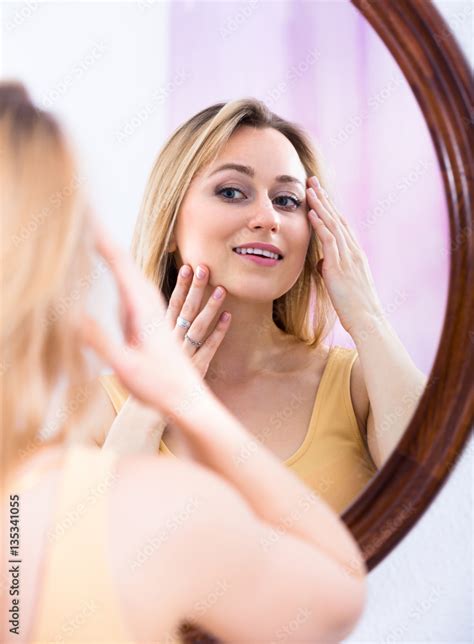 Foto Stock Young Woman Looking In The Mirror Adobe Stock