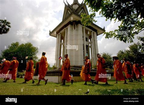 Cambodian Buddhist Monks March Past The Stupa Of Choeung Ek Memorial