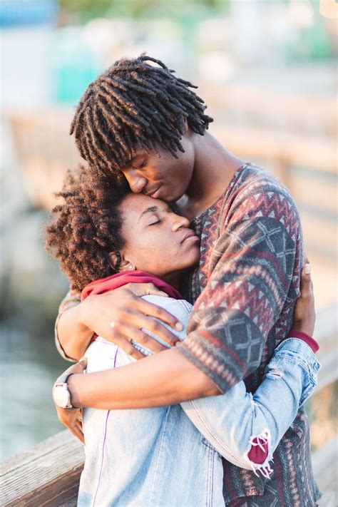 Two People Embracing Each Other On A Bridge