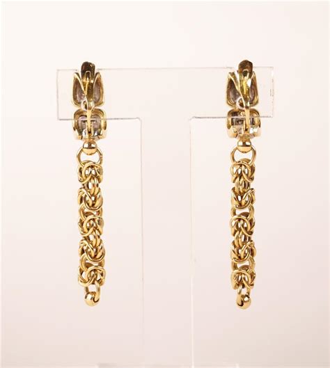 Paire de boucles d oreilles en or jaune 18 K 750 oo ornées d éclats