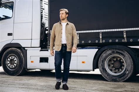 Premium Photo | Truck driver standing by his lorry