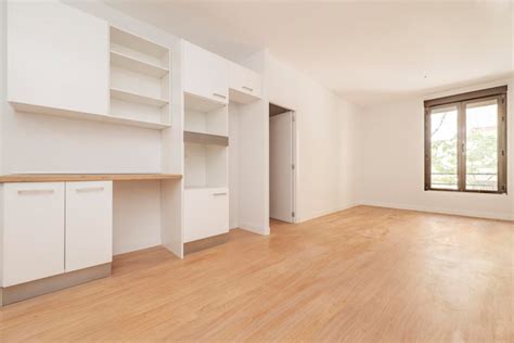 Premium Photo Empty Living Room With Kitchen Cabinets On One Wall