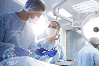 Team Of Professional Doctors Performing Operation In Surgery Room And