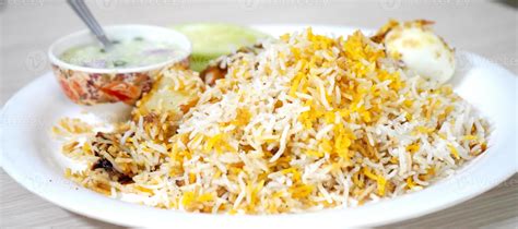 Special Kolkata Chicken Biryani Served With Raita Stock Photo