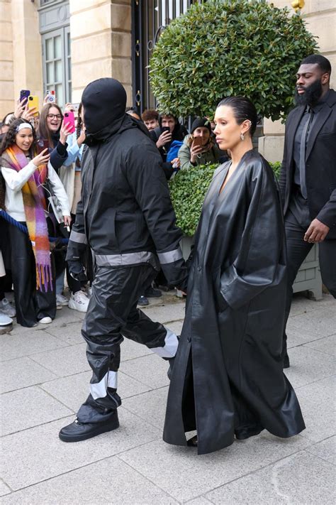 Bianca Censori Covers Up In Black Trench Coat As Kanye West Dons Black