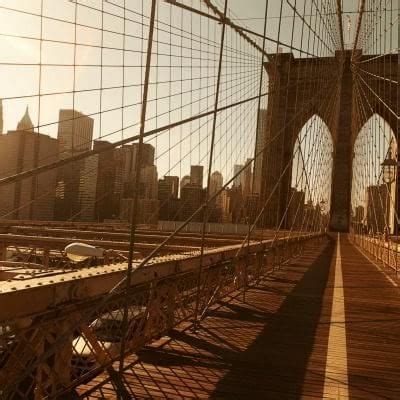 The Sun Is Setting Over The Brooklyn Bridge