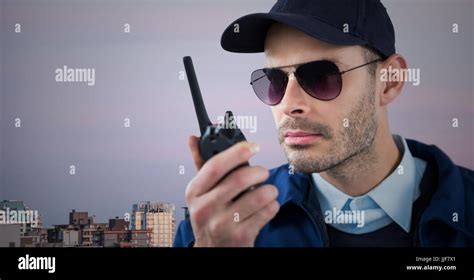 Digital Composite Of Security Guard With Walkie Talkie Against Skyline